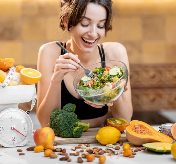Smiling woman enjoying a healthy salad